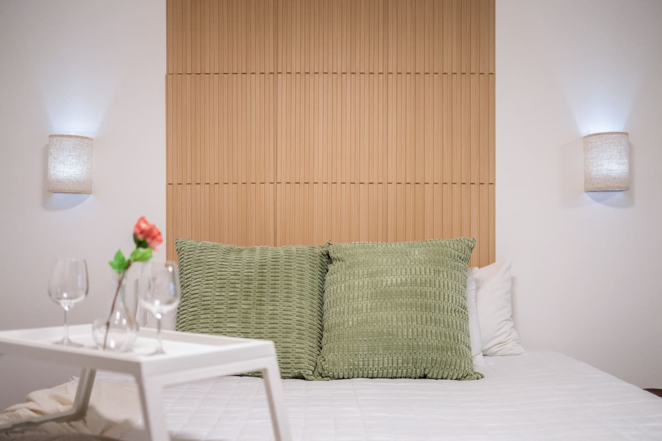 Bedroom with a wooden headboard and two pillows — Condado Penthouse, Condado