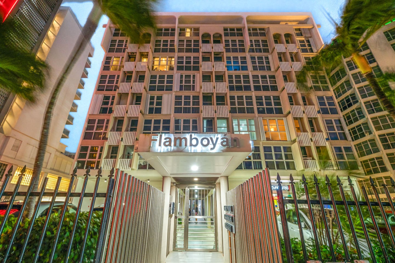 Building's front gate and entrance at dusk — Condado Penthouse