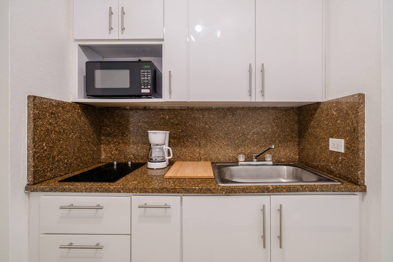 Kitchen with a microwave and a coffee maker on the counter — Condado Penthouse