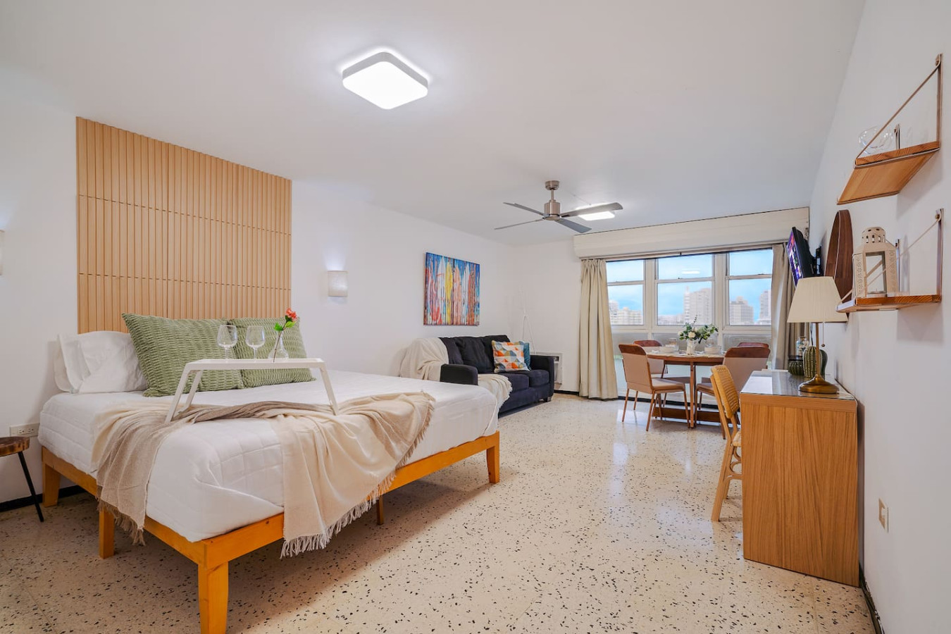Bedroom with a bed, nightstand, and a painting on the wall — Condado Penthouse, Condado
