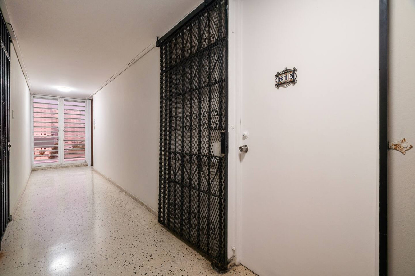 Building's hallway to the apartment's gated door — Condado Penthouse