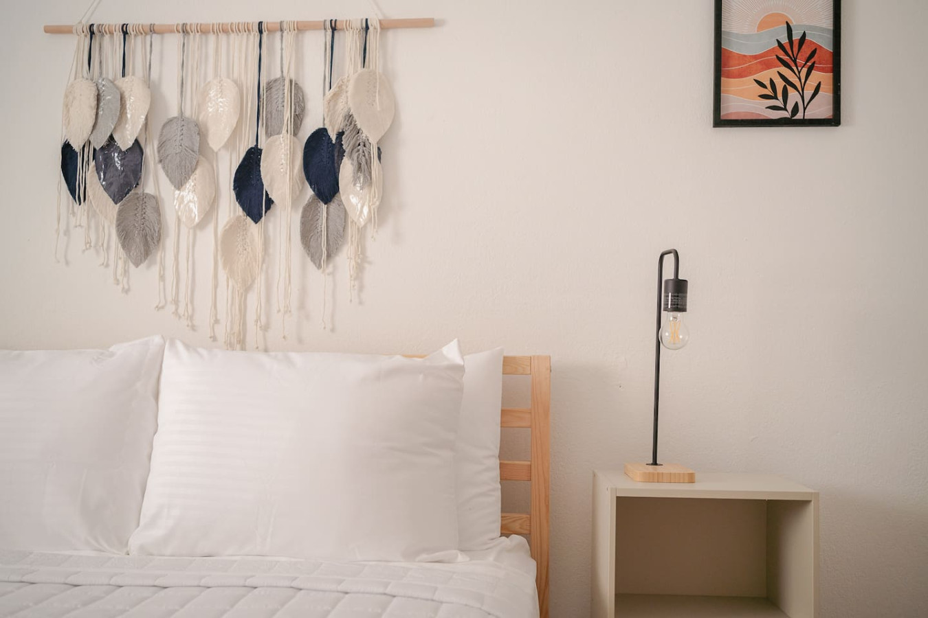 White bed with a white pillow and a wooden headboard in a bedroom — Puerto Lagoon Downtown, Santurce