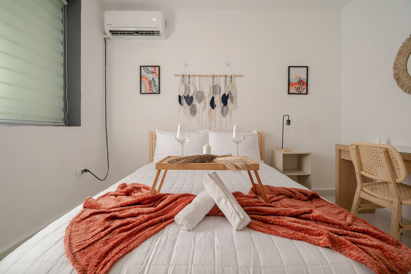 Bedroom with a bed and a table with two white towels on it — Puerto Lagoon Downtown, Santurce