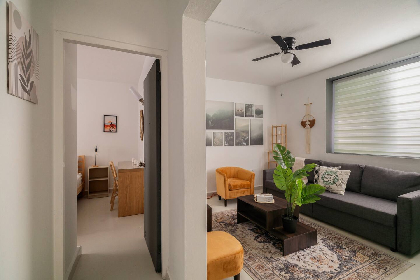 Living room with a ceiling fan and an open bedroom door — Puerto Lagoon Downtown, Santurce