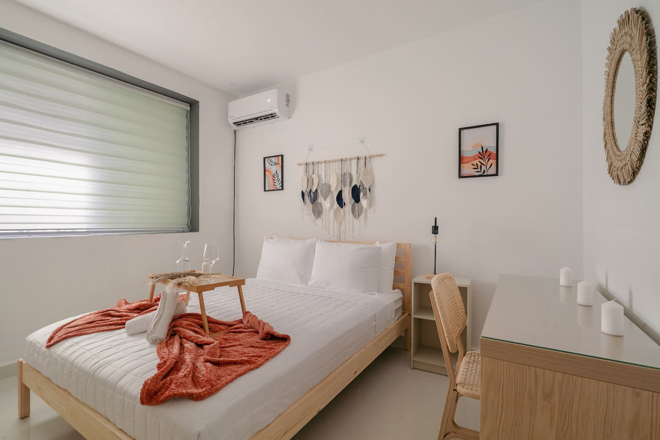 Bedroom with a bed and a table with wine glasses on it — Puerto Lagoon Downtown, Santurce