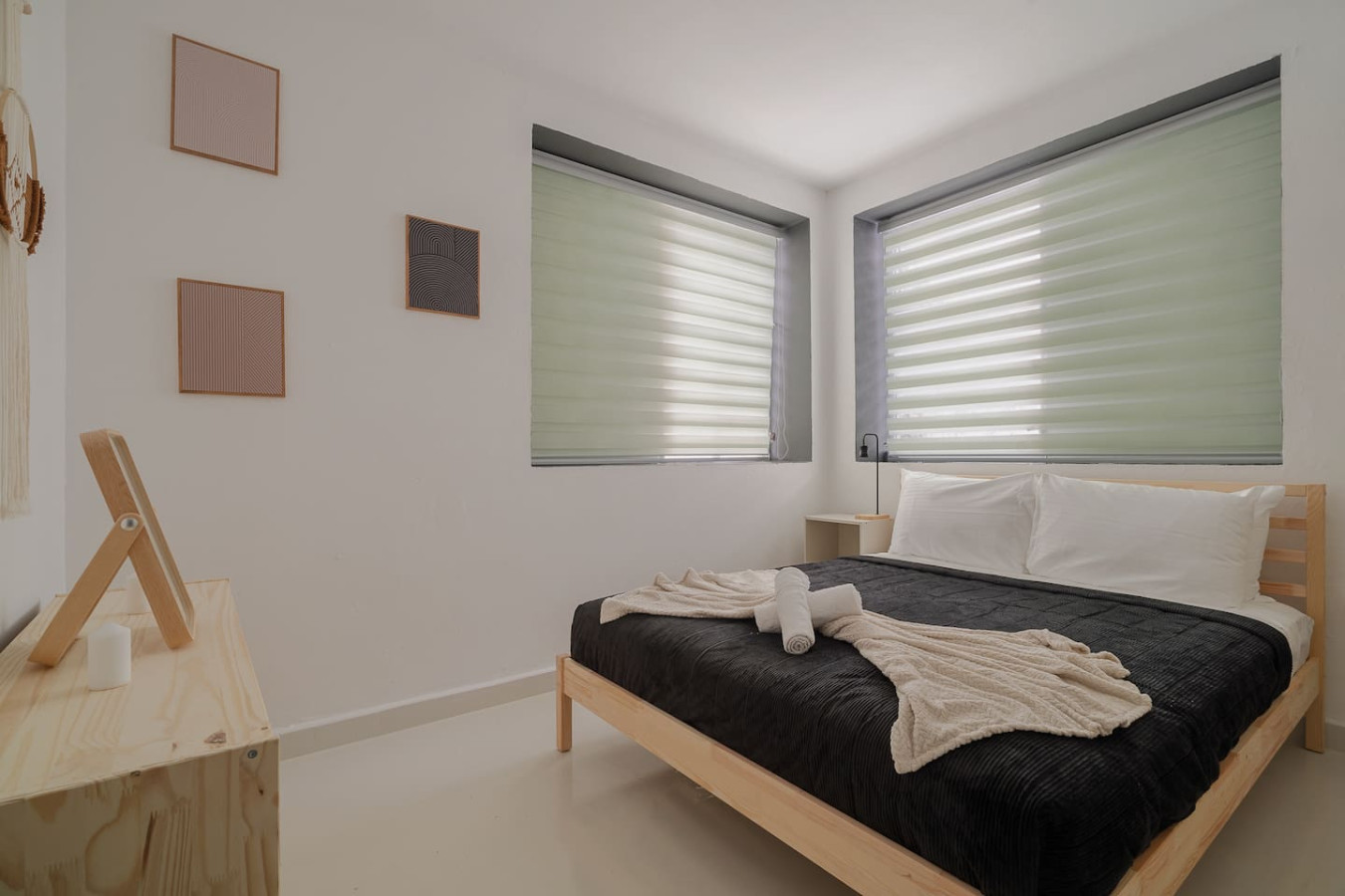 Bedroom with a black bed and a white blanket on it — Puerto Lagoon Downtown, Santurce