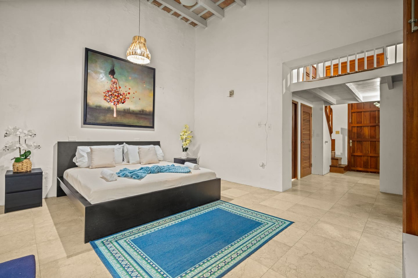 Bedroom with a blue rug and a painting on the wall — Grand Palazzo del Mar, Old San Juan