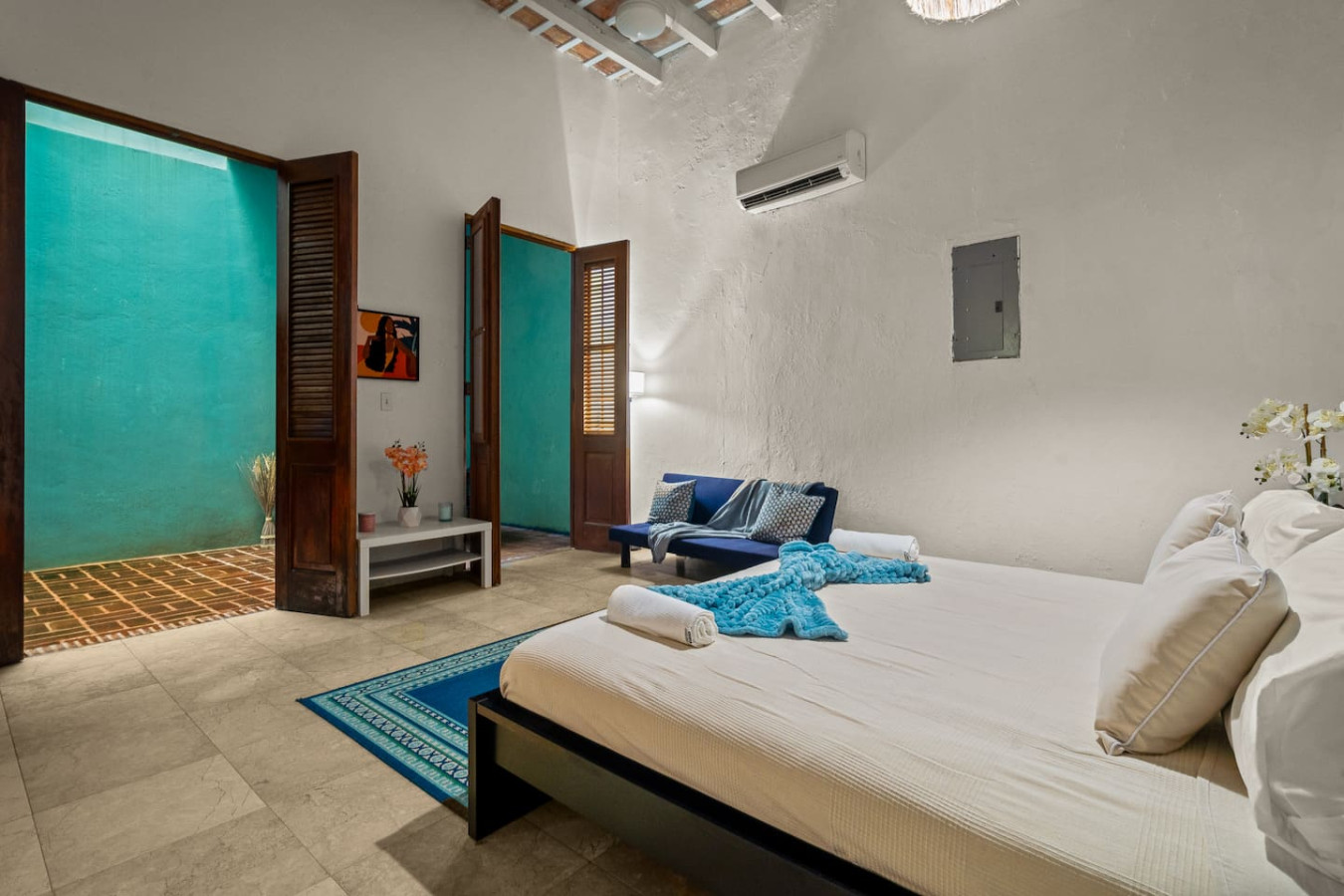 Bedroom with a blue bedspread and a blue blanket on it — Grand Palazzo del Mar, Old San Juan