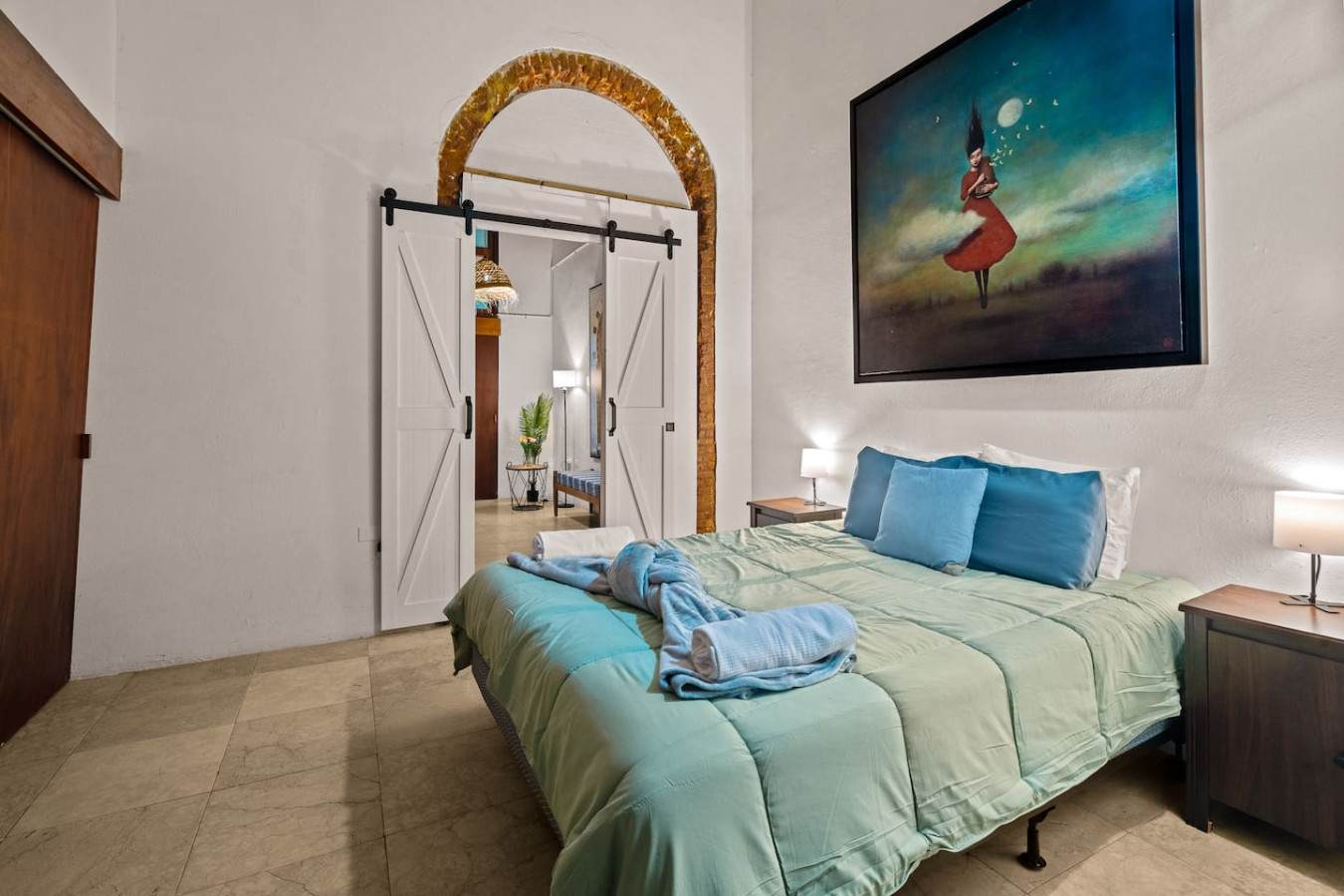 Bedroom with a blue bedspread and a painting on the wall — Grand Palazzo del Mar, Old San Juan