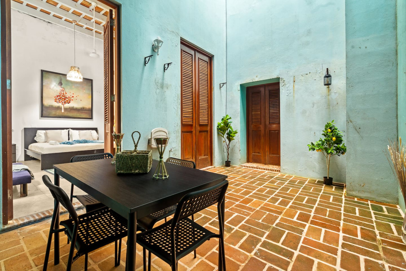 Black dining table with chairs in front of a blue wall — Grand Palazzo del Mar, Old San Juan