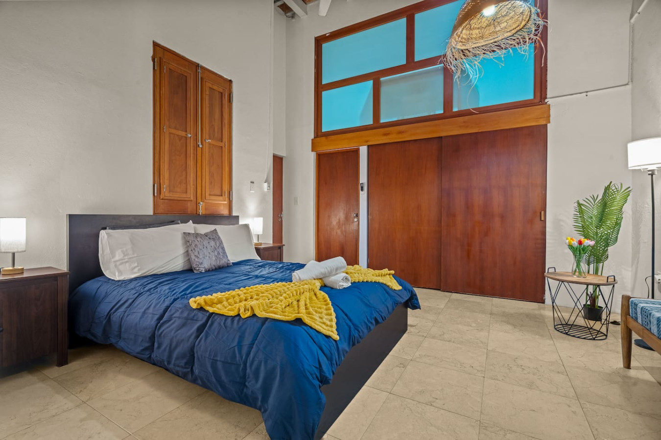 Bedroom with a blue bedspread and yellow throw blanket — Grand Palazzo del Mar, Old San Juan