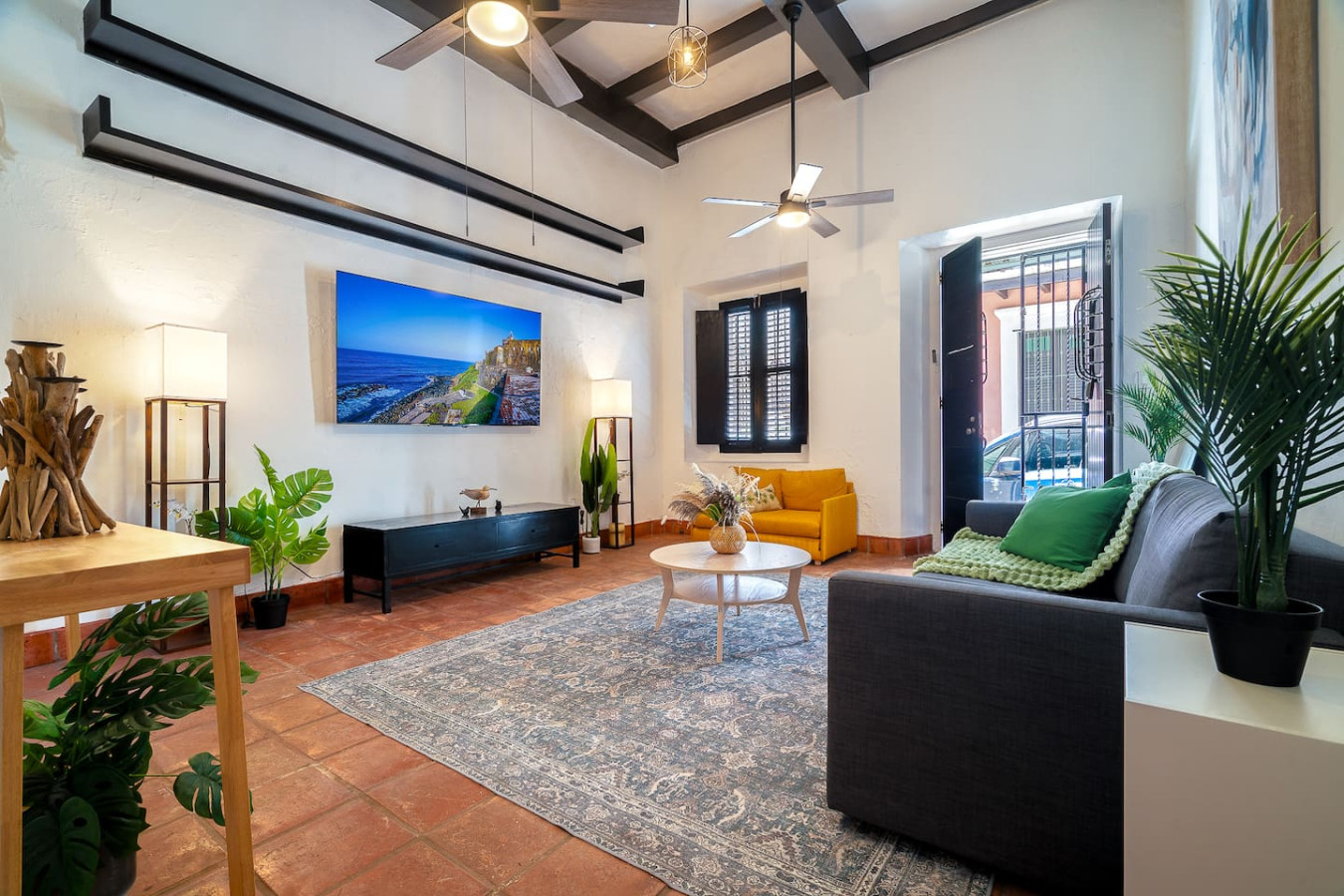 Living room with a flat screen TV, a couch, and a coffee — Villa Mansion - Fountain & Rooftop - Old San Juan, Old San Juan
