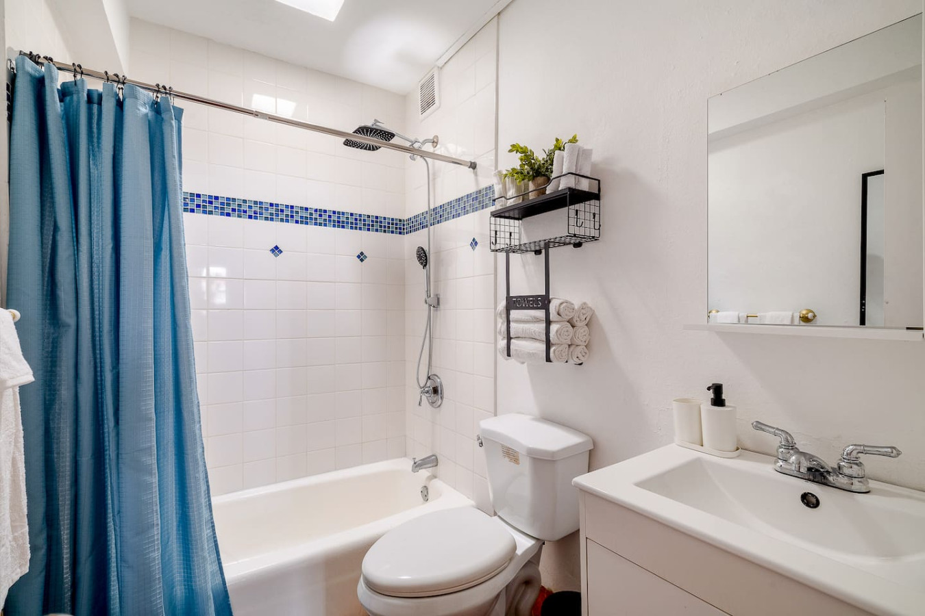 Bathroom with a tub and a blue shower curtain — Villa Mansion - Fountain & Rooftop - Old San Juan