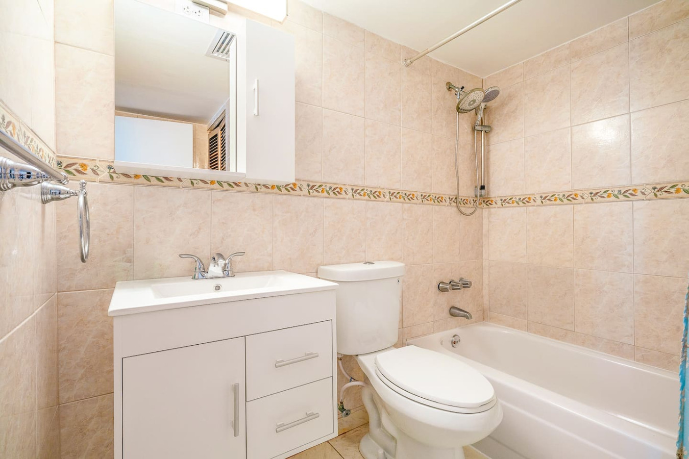 Bathroom with a tub-shower, vanity and beige tile — Captain’s Beachfront Luquillo Beach House