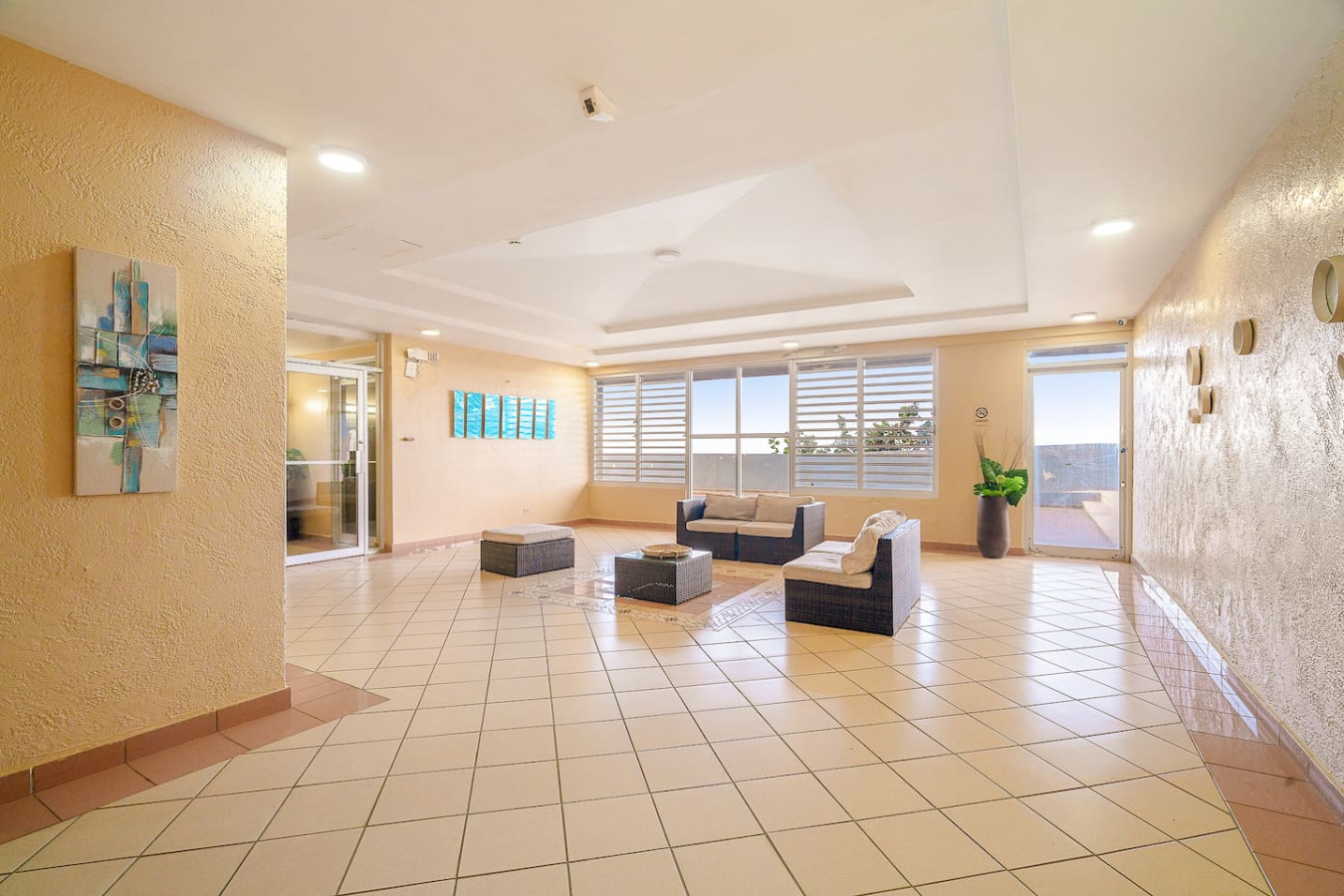 Living room with a couch and a coffee table — Captain’s Beachfront Luquillo Beach House, Luquillo