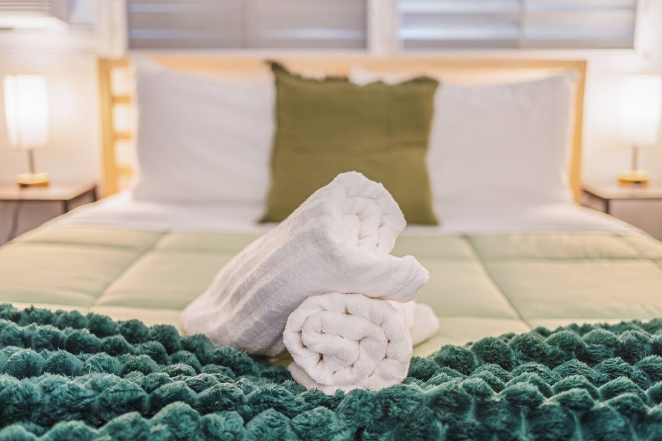 Bedroom with a bed and a green pillow — Tapia Mosaic Beachwalk - San Juan, Santurce
