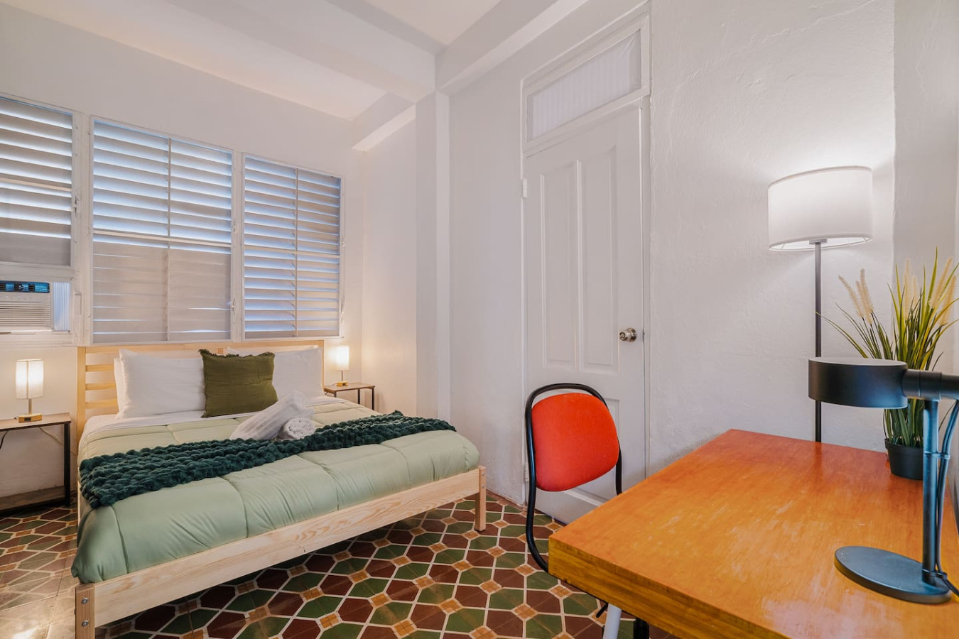 Bedroom with a bed, a chair, and a table — Tapia Mosaic Beachwalk - San Juan, Santurce