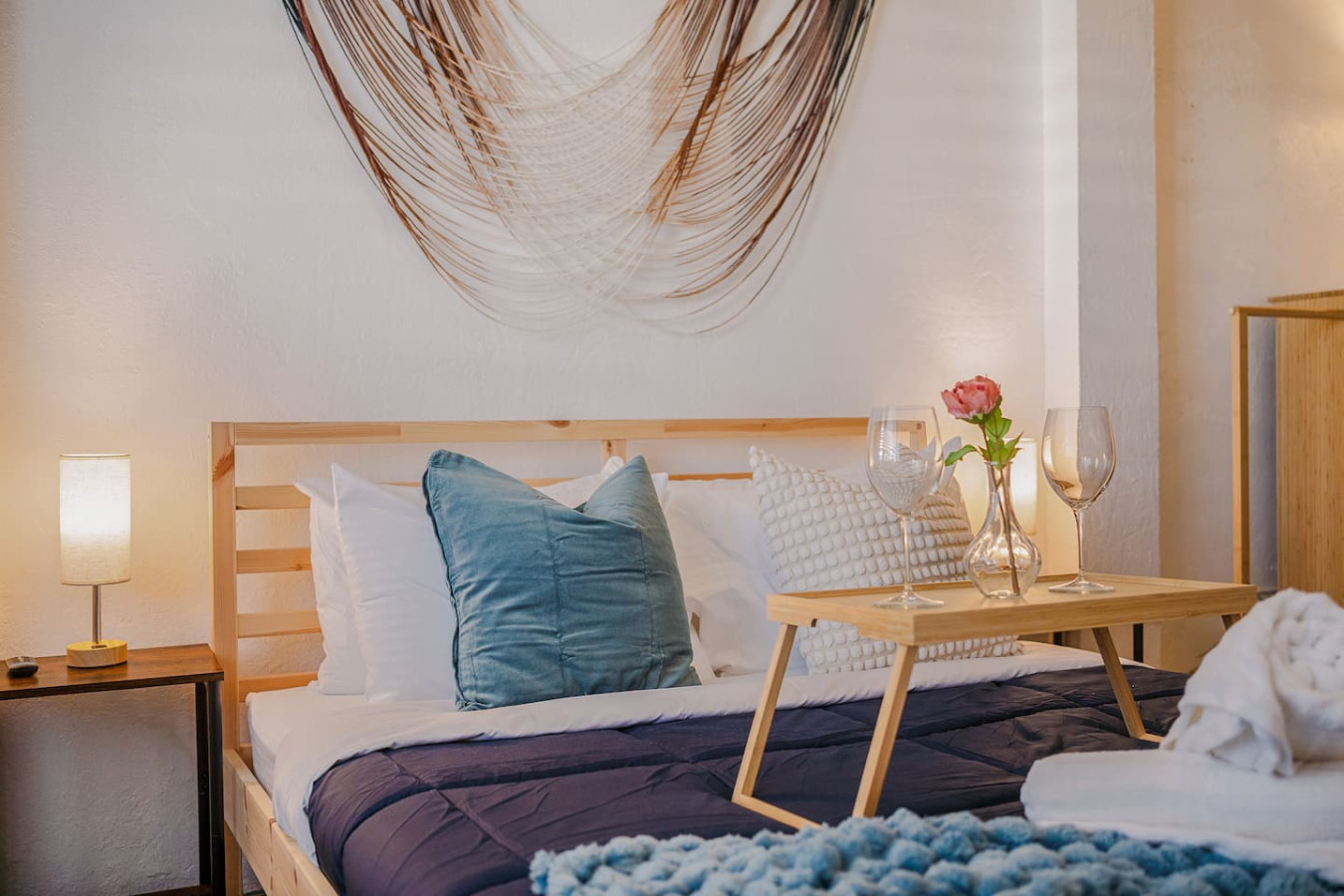 Bedroom with a blue bedspread and a wooden headboard — Tapia Mosaic Beachwalk - San Juan, Santurce