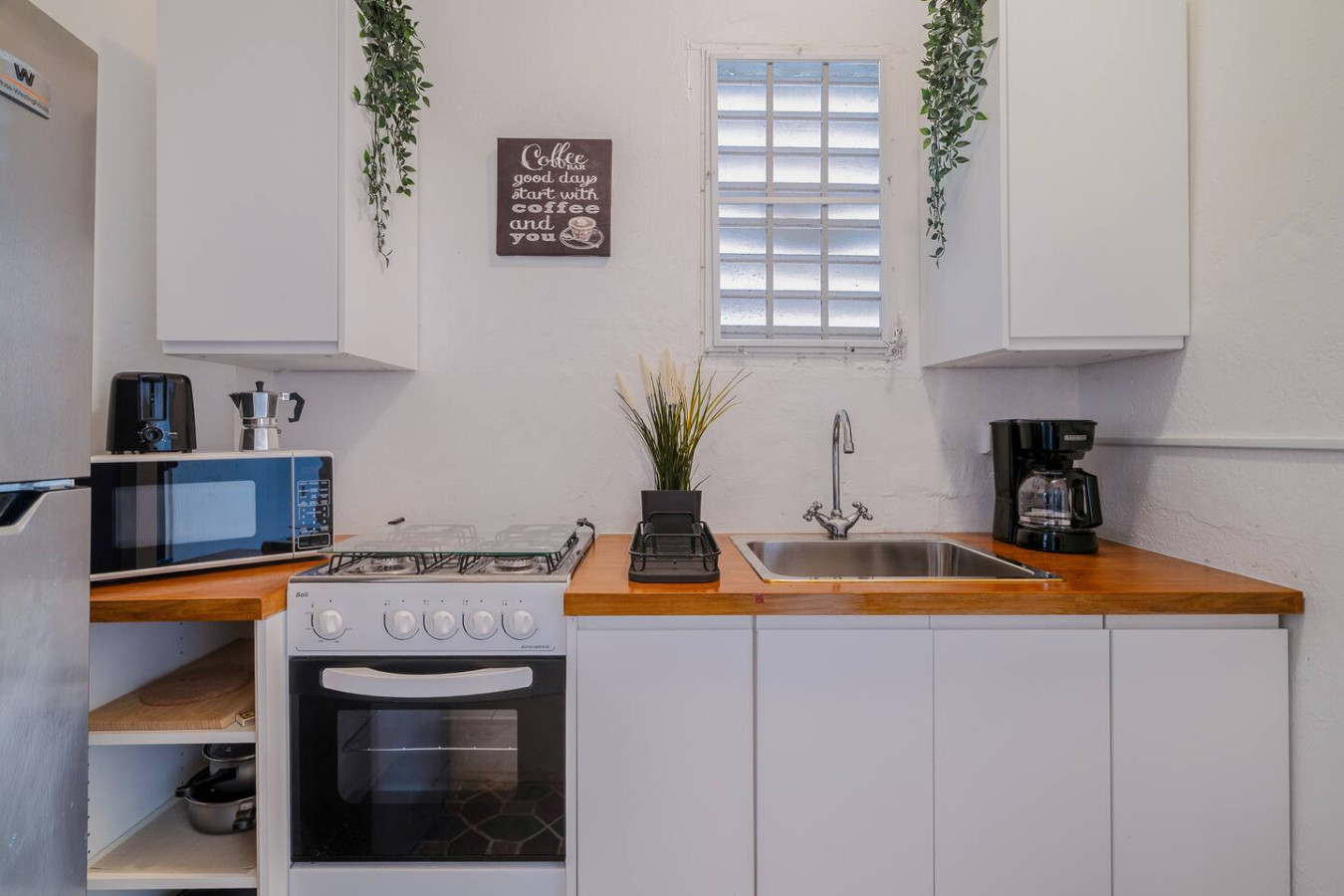 Kitchen with a wood counter, sink and coffee maker — Tapia Mosaic Beachwalk - San Juan, Santurce