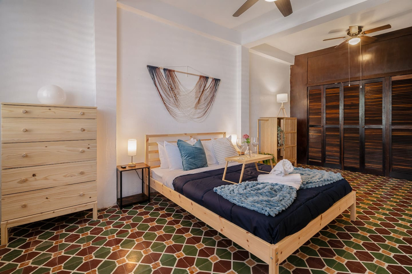 Bedroom with a blue bedspread and a white pillow — Tapia Mosaic Beachwalk - San Juan, Santurce