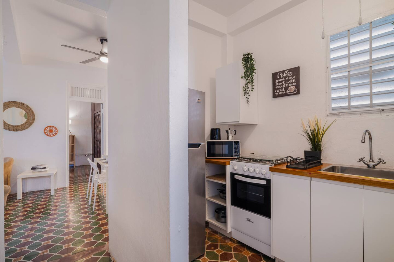 Kitchen with a gas stove, fridge and open shelves — Tapia Mosaic Beachwalk - San Juan, Santurce