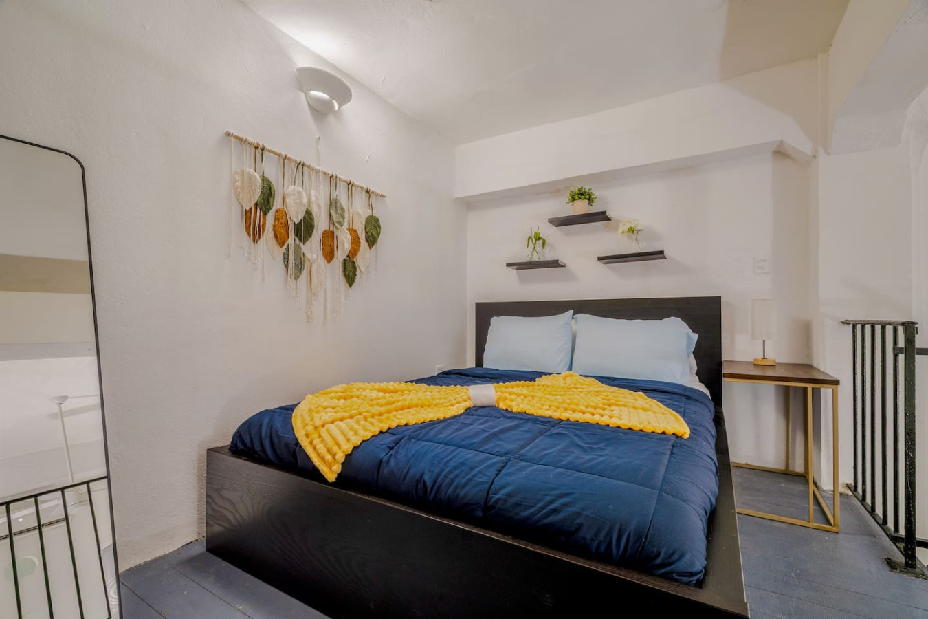 Bedroom with a blue bedspread and yellow throw blanket — Loft La Luz - Old San Juan, Old San Juan
