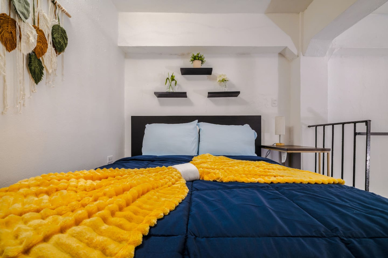 Bedroom with a blue bedspread and yellow blanket — Loft La Luz - Old San Juan, Old San Juan