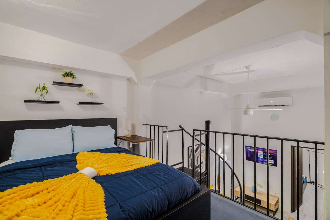 Bedroom with a yellow and blue blanket on the bed — Loft La Luz - Old San Juan, Old San Juan