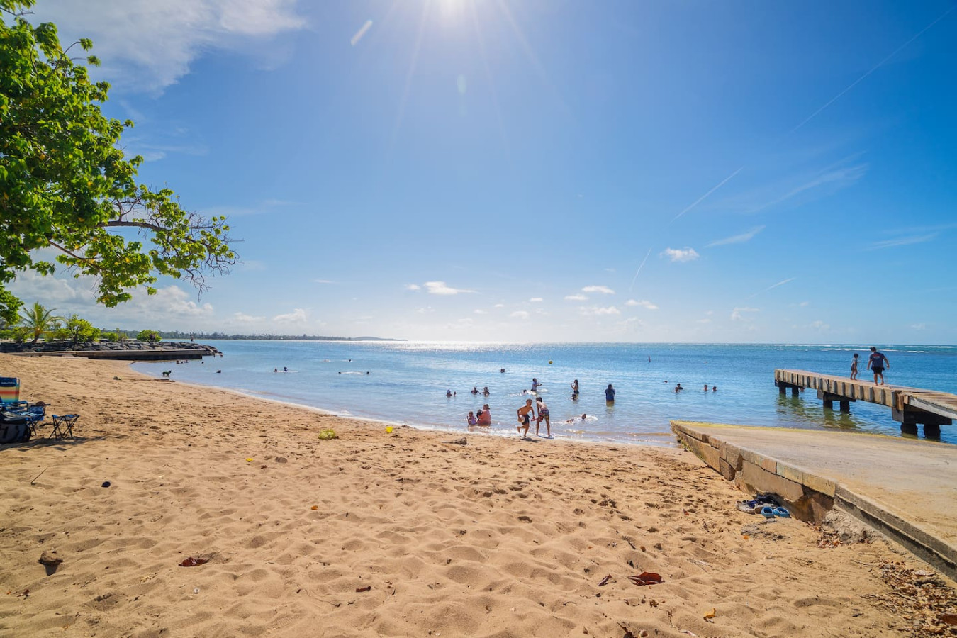 Beach with people swimming and a boat in the water — Beach Villa Dorado Del Mar, Dorado