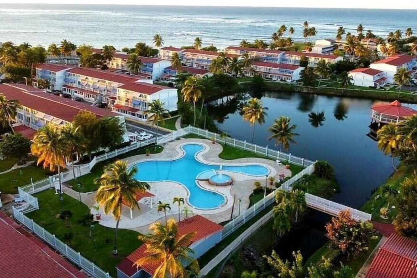 Blue swimming pool with a white tile border and a red roof — Beach Villa Dorado Del Mar, Dorado