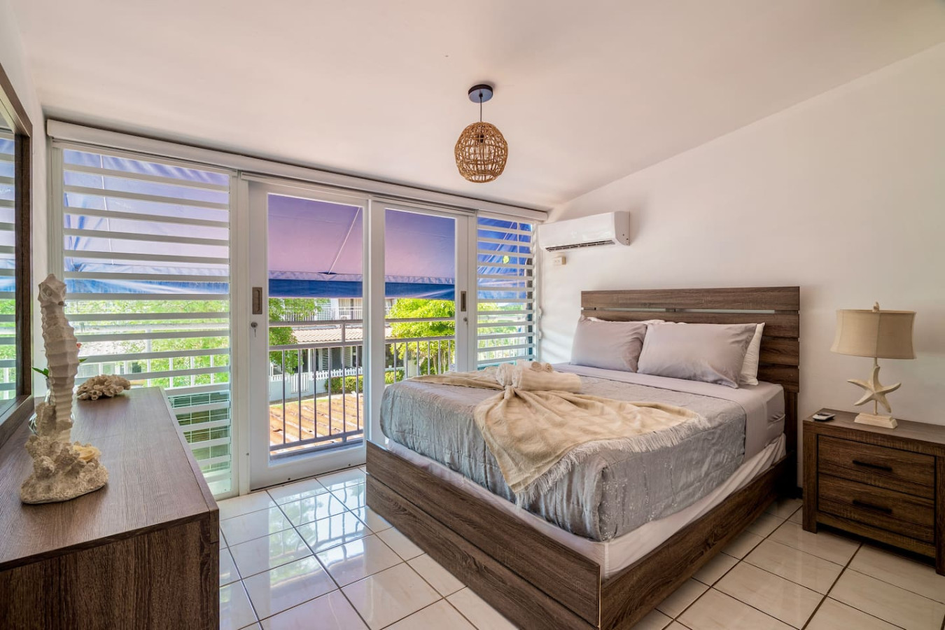 Bedroom with a queen bed and glass doors to a balcony — Beach Villa Dorado Del Mar
