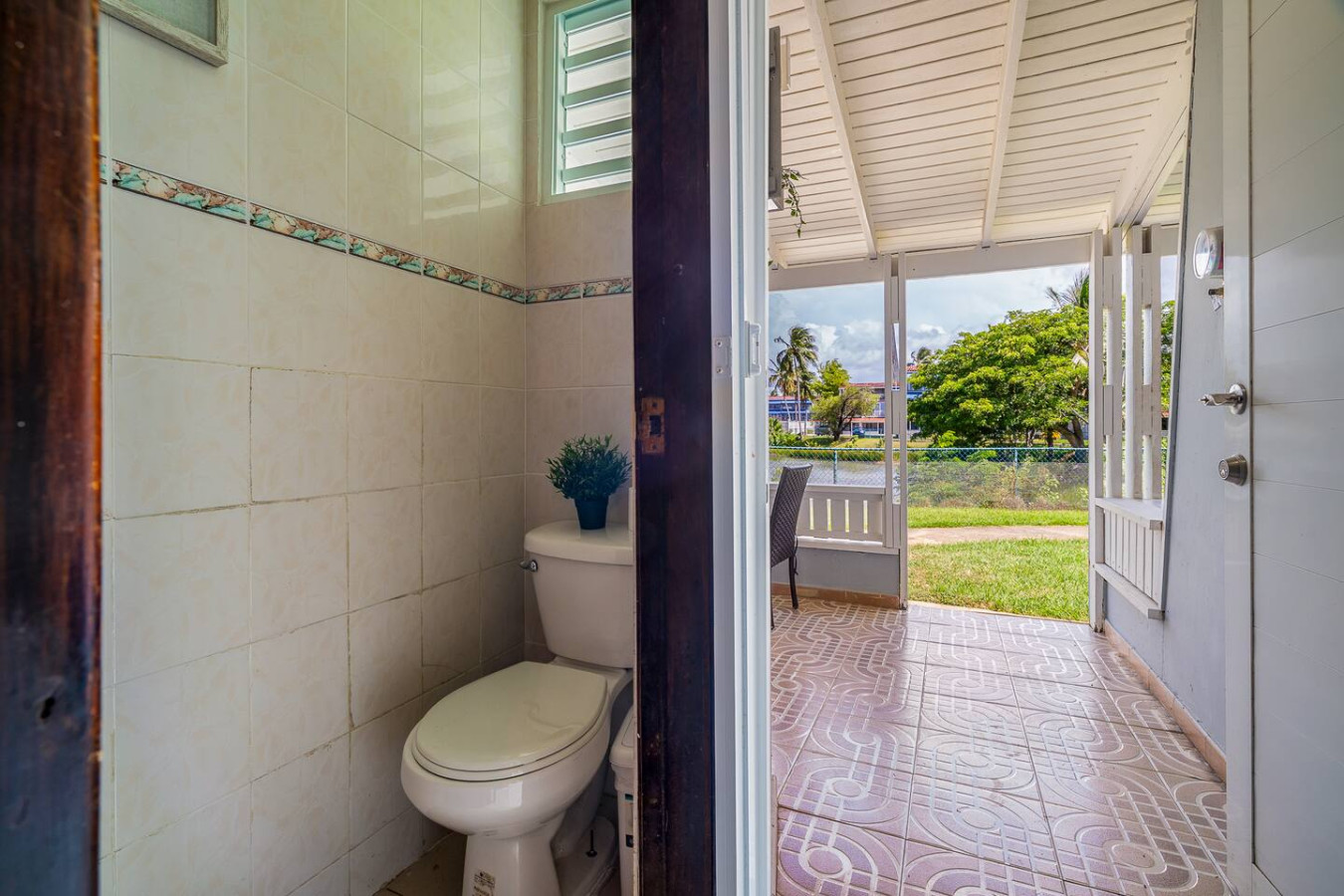 Half bathroom with a door to the covered patio — Beach Villa Dorado Del Mar
