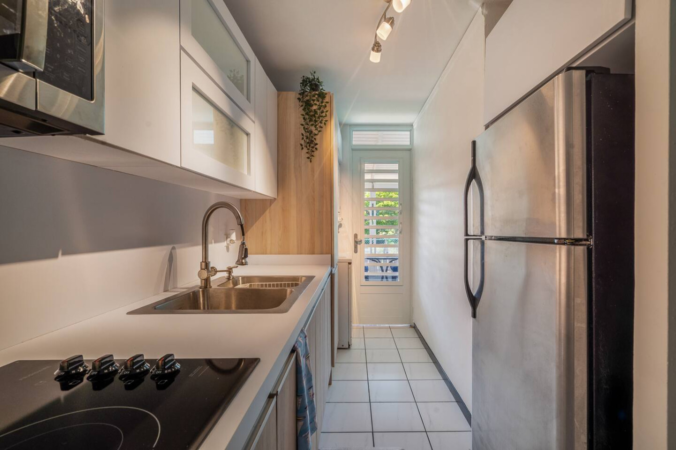 Galley kitchen with a stainless steel fridge — Beach Villa Dorado Del Mar
