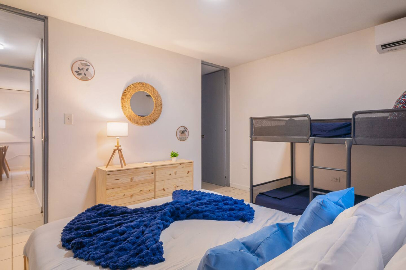 Bedroom with a bunk bed, a dresser and a round mirror — Condado Grass Patio, Santurce