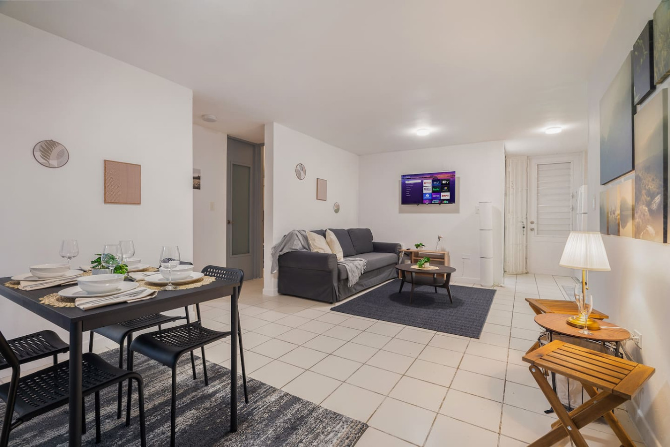 Living room with a couch and a flat screen TV (balcony 2) — Condado Grass Patio, Santurce