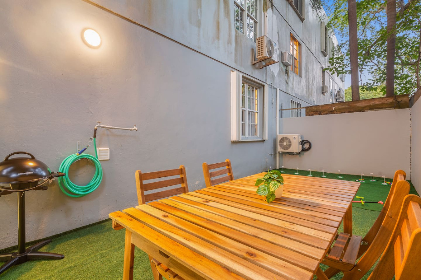 Patio with a grill and wooden outdoor furniture — Condado Grass Patio, Santurce