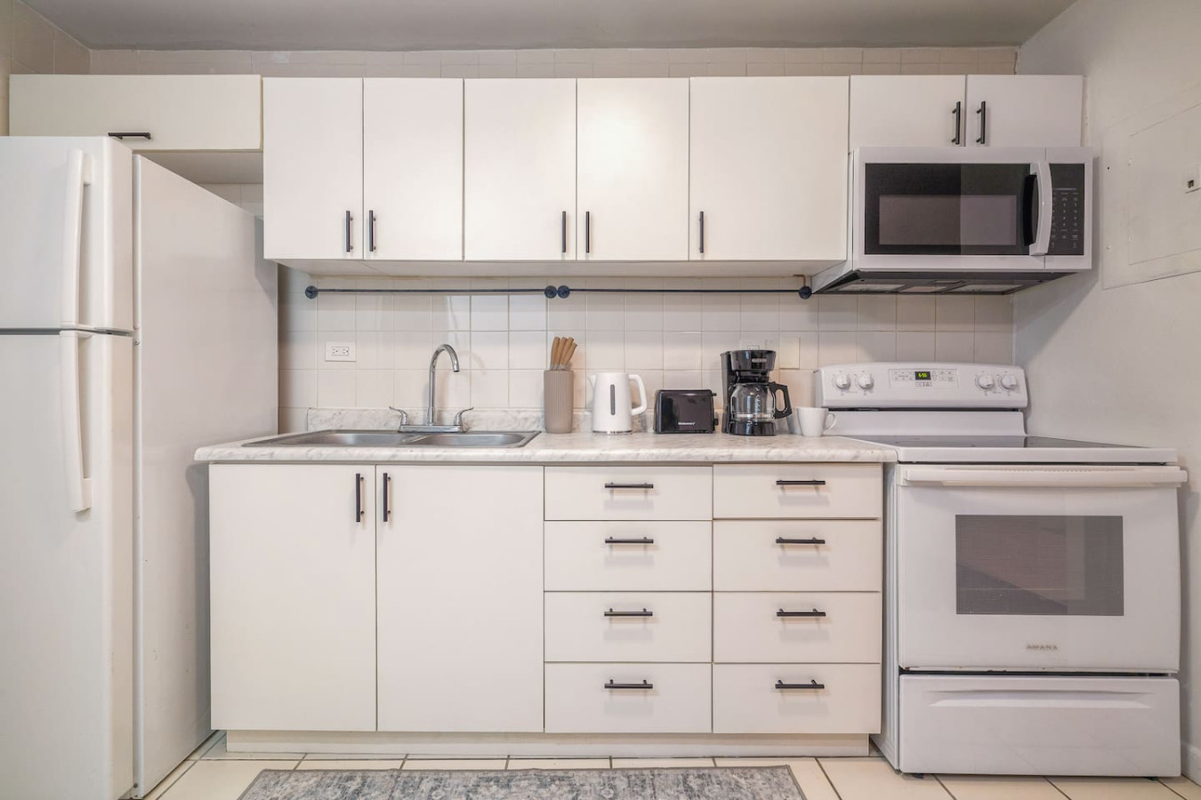 Kitchen with white cabinets and a sink — Condado Grass Patio, Santurce