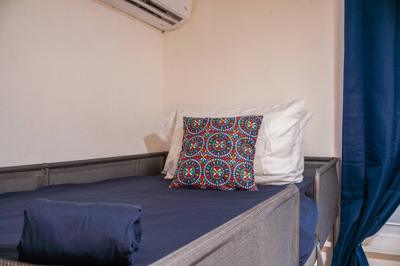 Bedroom with a colorful pillow on a bed — Condado Grass Patio, Santurce