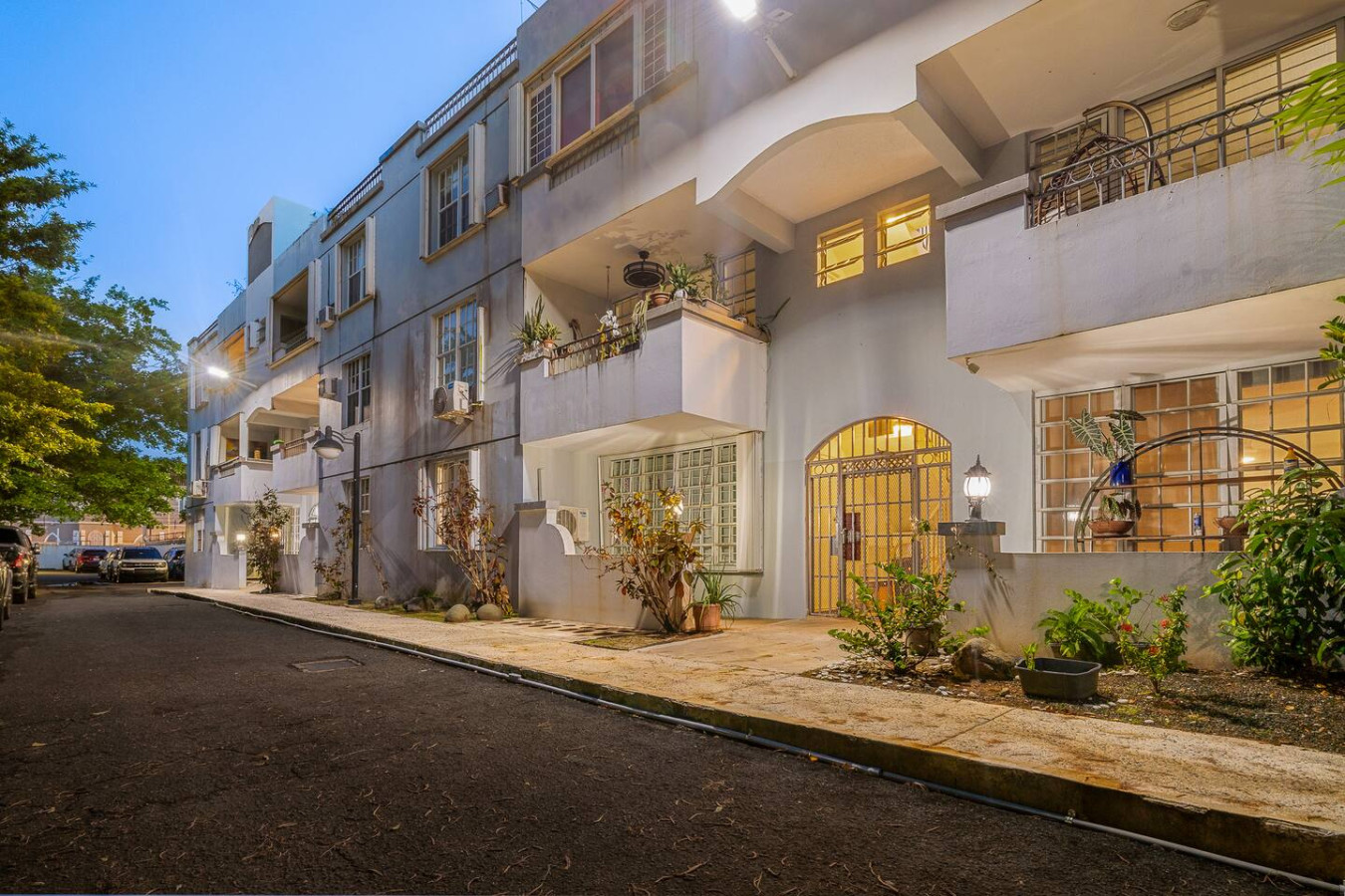 Building at dusk with an arched entrance and balconies — Condado Grass Patio, Santurce
