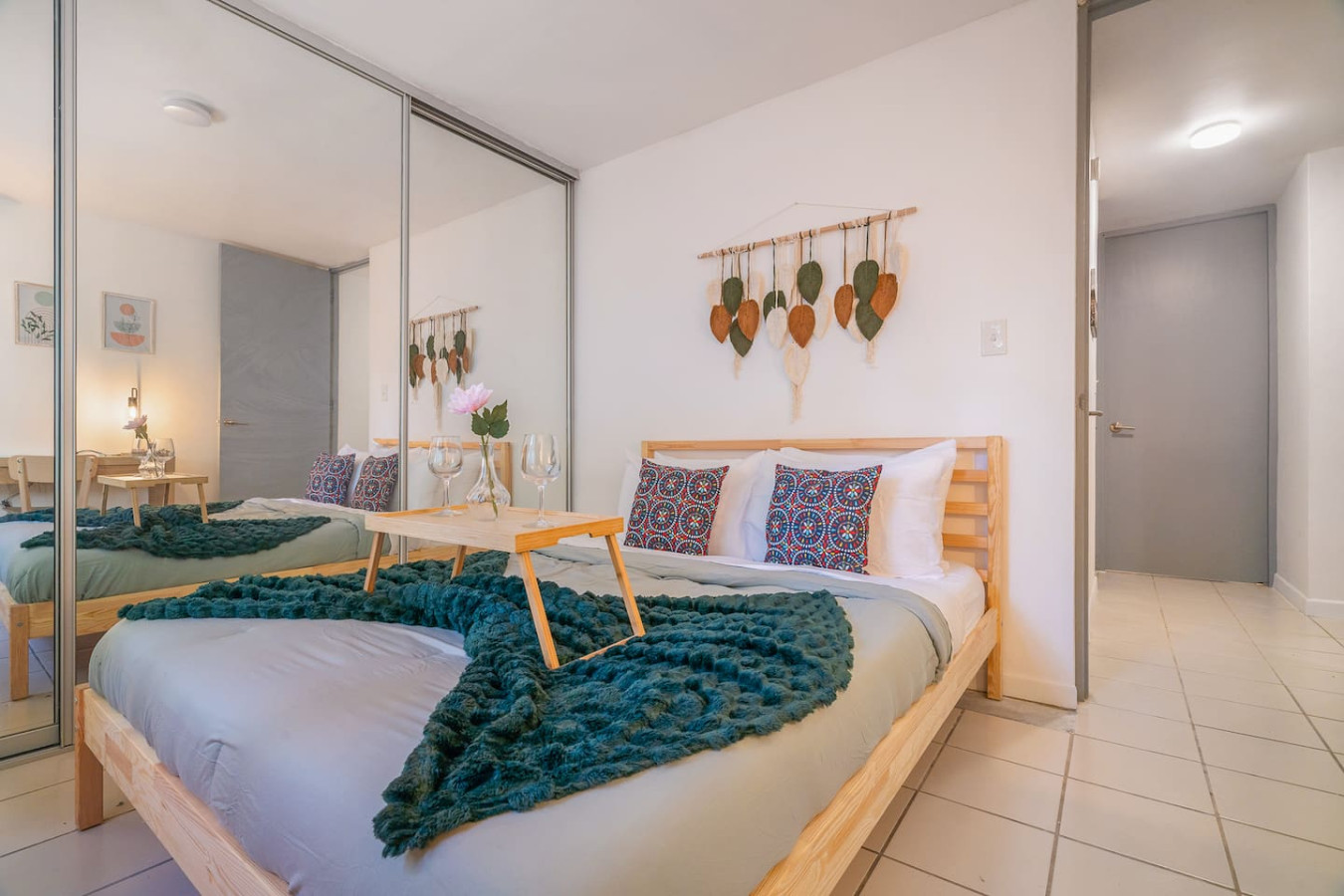 Bedroom with a bed, a table, and a mirror — Condado Grass Patio, Santurce