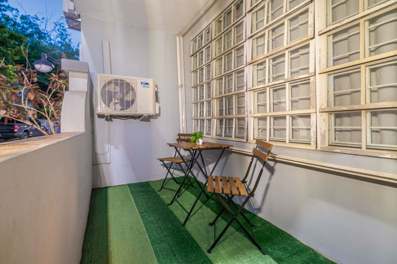 Side patio with a bistro table and two chairs — Condado Grass Patio, Santurce