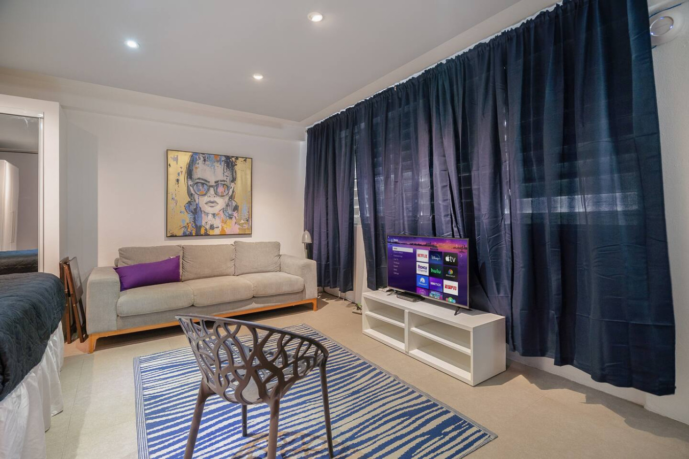 Living room with a couch, chair, and television — Punta Las Marias Studio - Short Walk to the Beach, Santurce