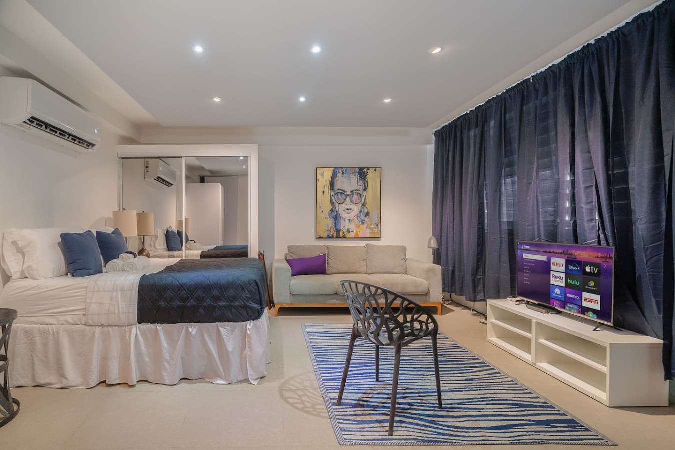 Bedroom with a bed, a chair, and a painting on the wall — Punta Las Marias Studio - Short Walk to the Beach, Santurce