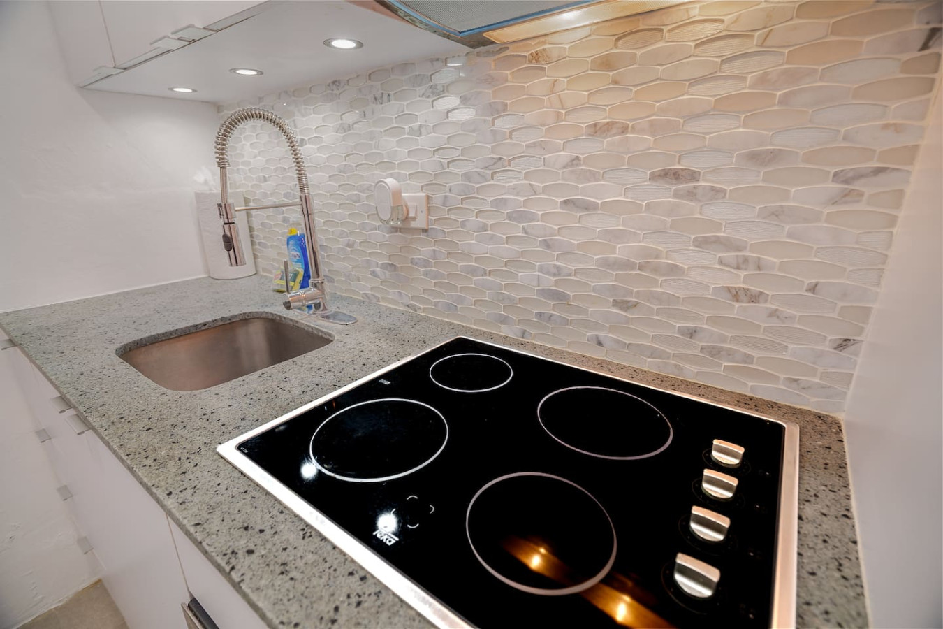 Kitchen with a glass cooktop and a steel sink — Punta Las Marias Studio - Short Walk to the Beach, Santurce
