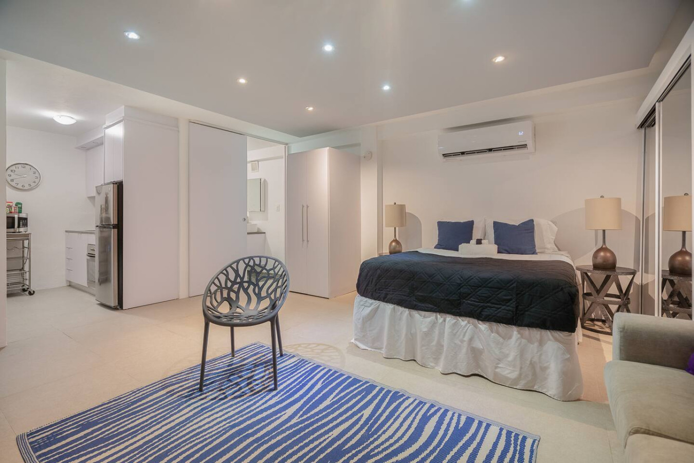 Bedroom with a bed, chair, and lamp — Punta Las Marias Studio - Short Walk to the Beach, Santurce