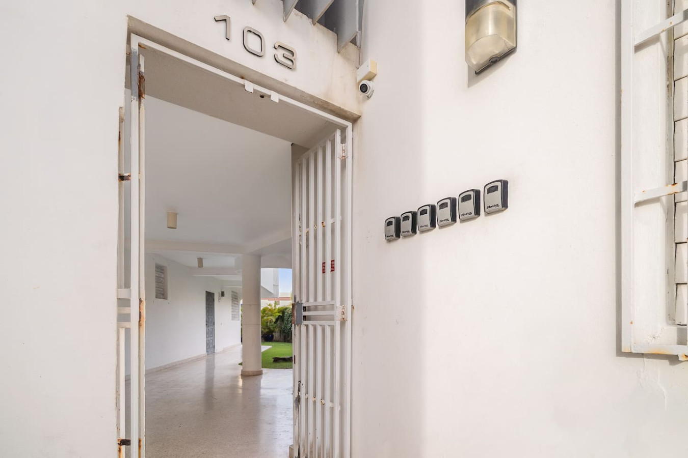 White house with a black door and a number 1030 on it — Punta Las Marias Studio - Short Walk to the Beach, Santurce