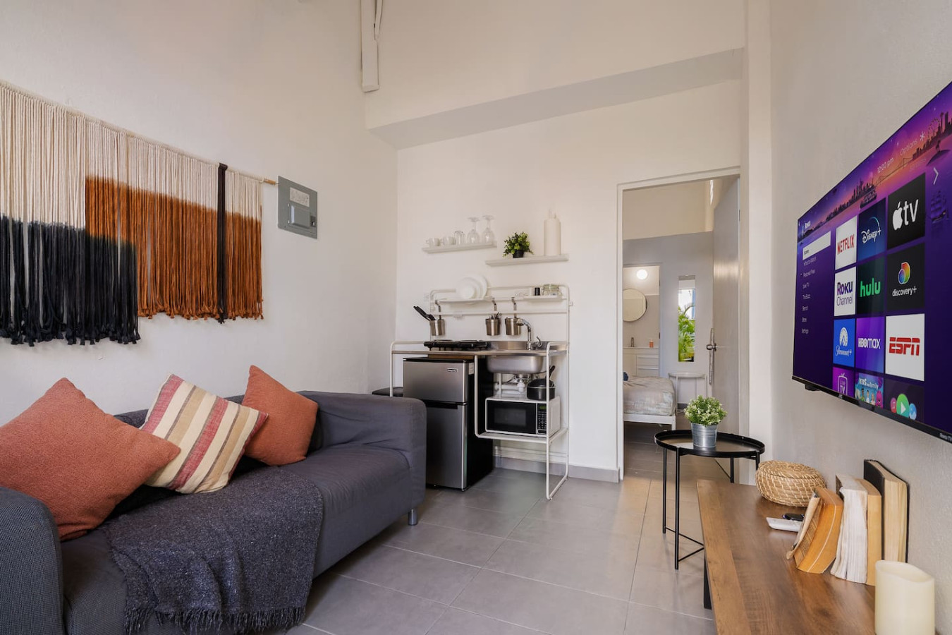 Small kitchen with a black refrigerator and a stove top oven — Downtown San Juan Gateway Dream, Santurce