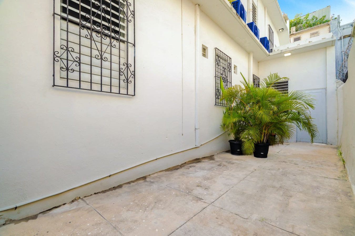 White building with a black balcony and a view of the ocean — Downtown San Juan Gateway Dream, Santurce