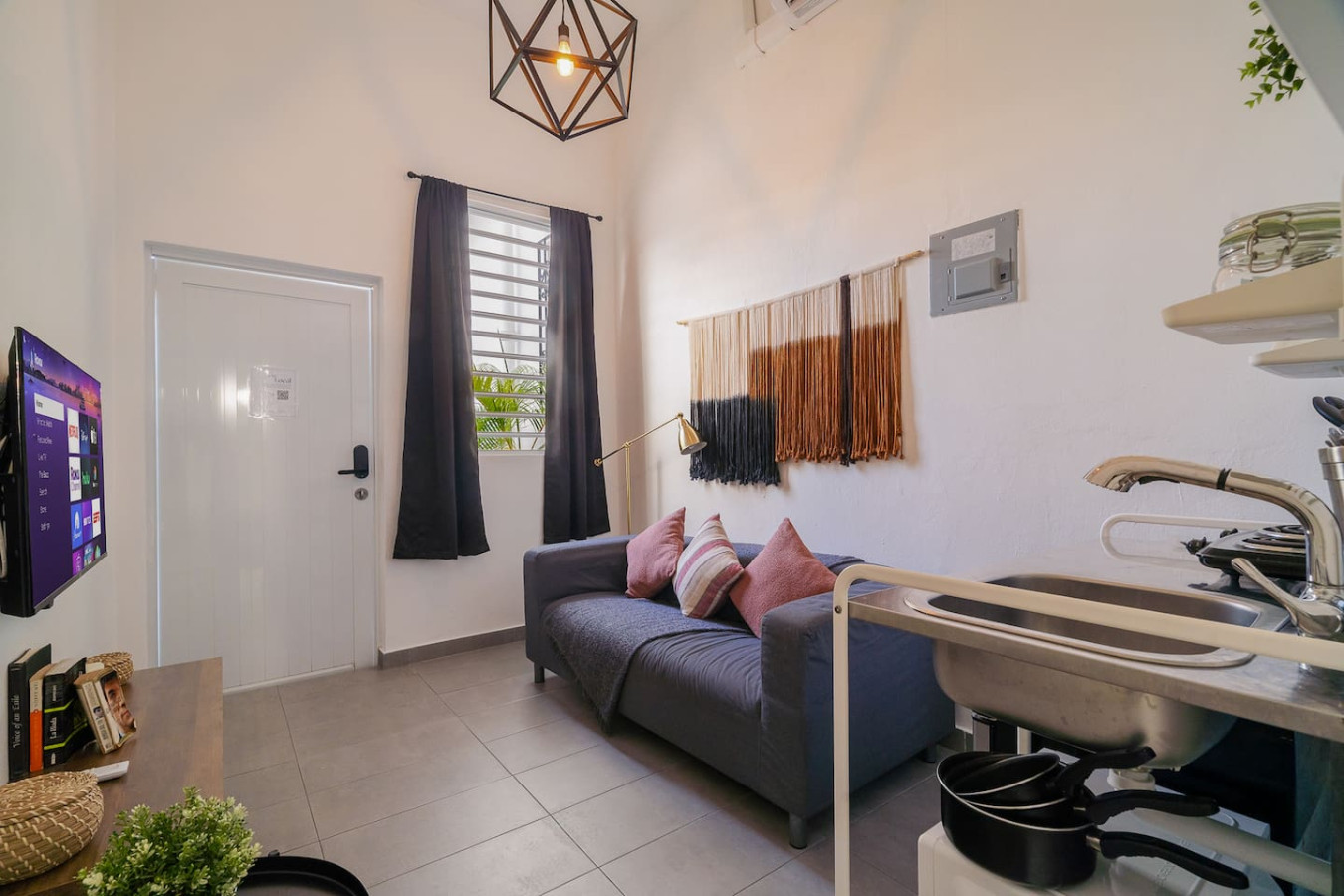 Living room with a couch and a window view — Downtown San Juan Gateway Dream, Santurce