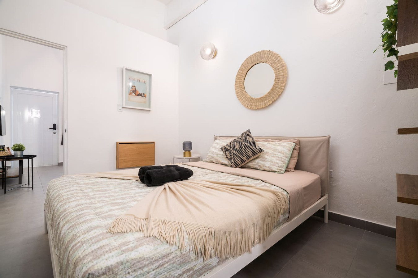 Bedroom with a bed, a mirror, and a rug on the floor — Downtown San Juan Gateway Dream, Santurce
